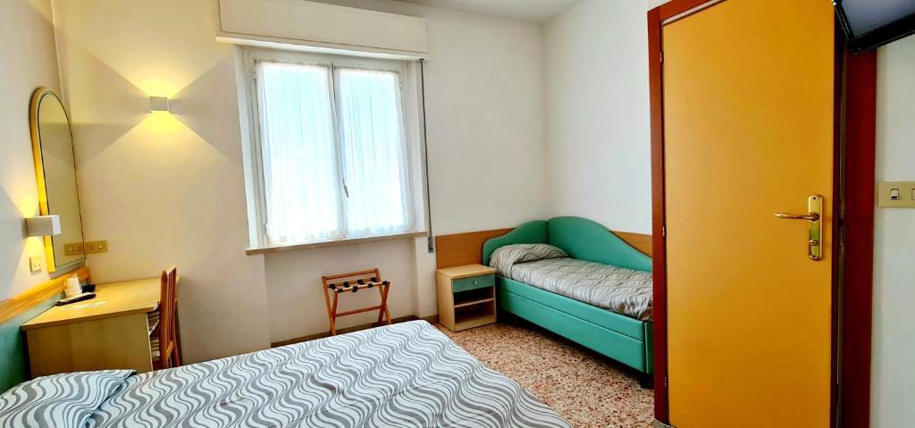 Postel nebo postele na pokoji v ubytování Hotel Bellerofonte