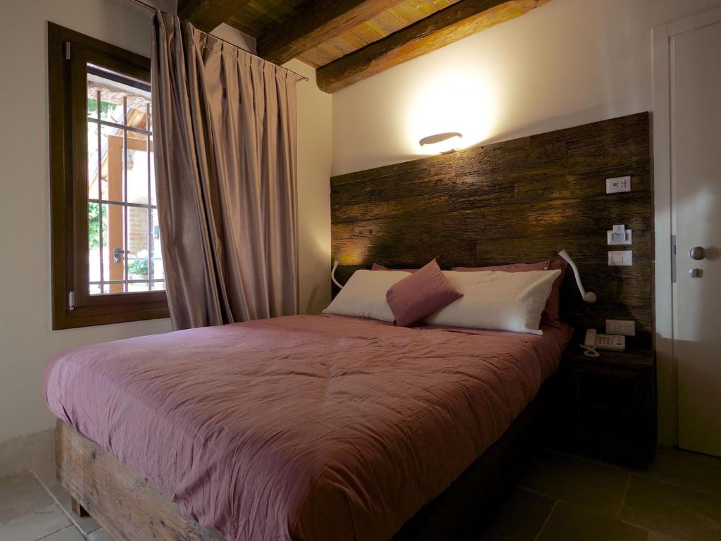 Postel nebo postele na pokoji v ubytování Hotel Antica Abbazia