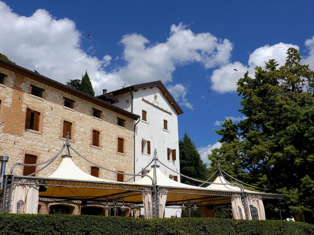 a large white building with a tent in front of it at Hotel Antica Abbazia in Borso del Grappa