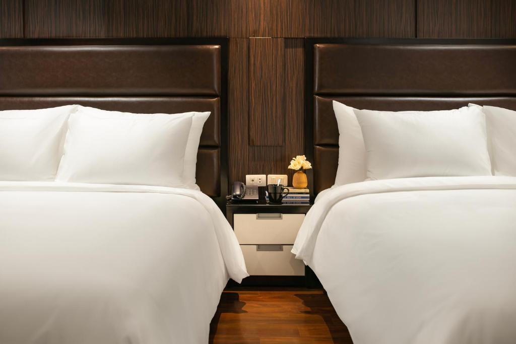 Postel nebo postele na pokoji v ubytování La Nueva Boutique Hotel Hanoi & Spa