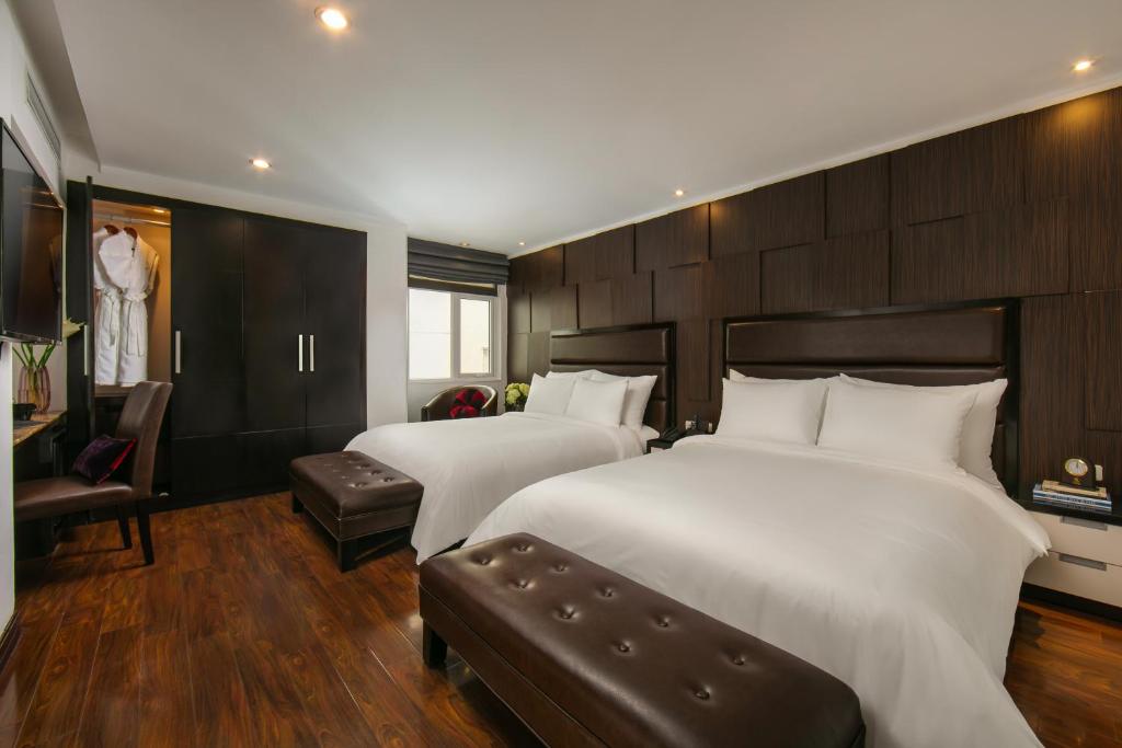 Postel nebo postele na pokoji v ubytování La Nueva Boutique Hotel Hanoi & Spa