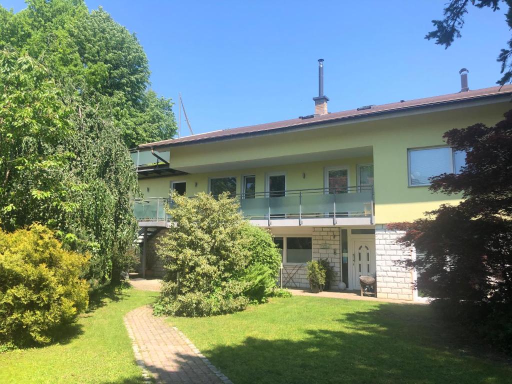 a large house with a lawn in front of it at Apartments Rose in winter in Bled