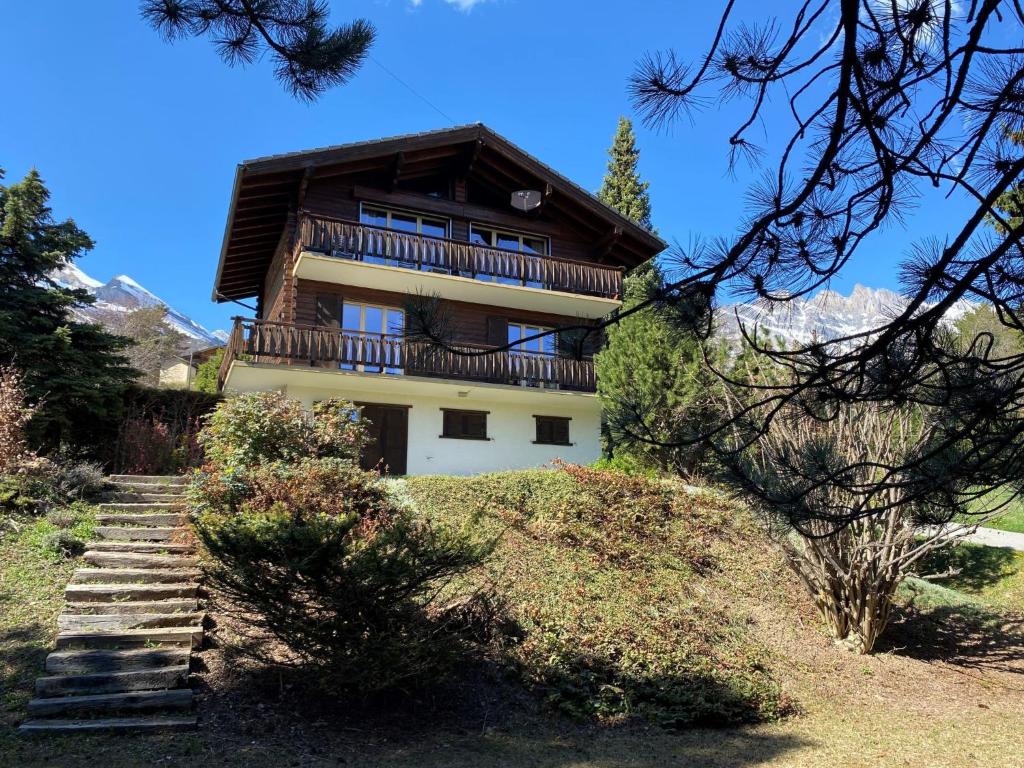 a building with a balcony on top of a hill at Chalet L'Alpage by Interhome in Ovronnaz
