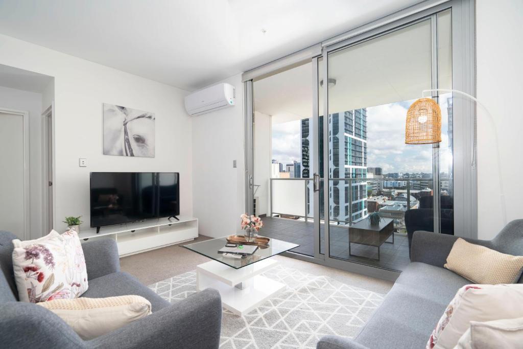 a living room with a tv and a large window at 152 City Rest With Views High Upparking Sleeps 2 in Perth