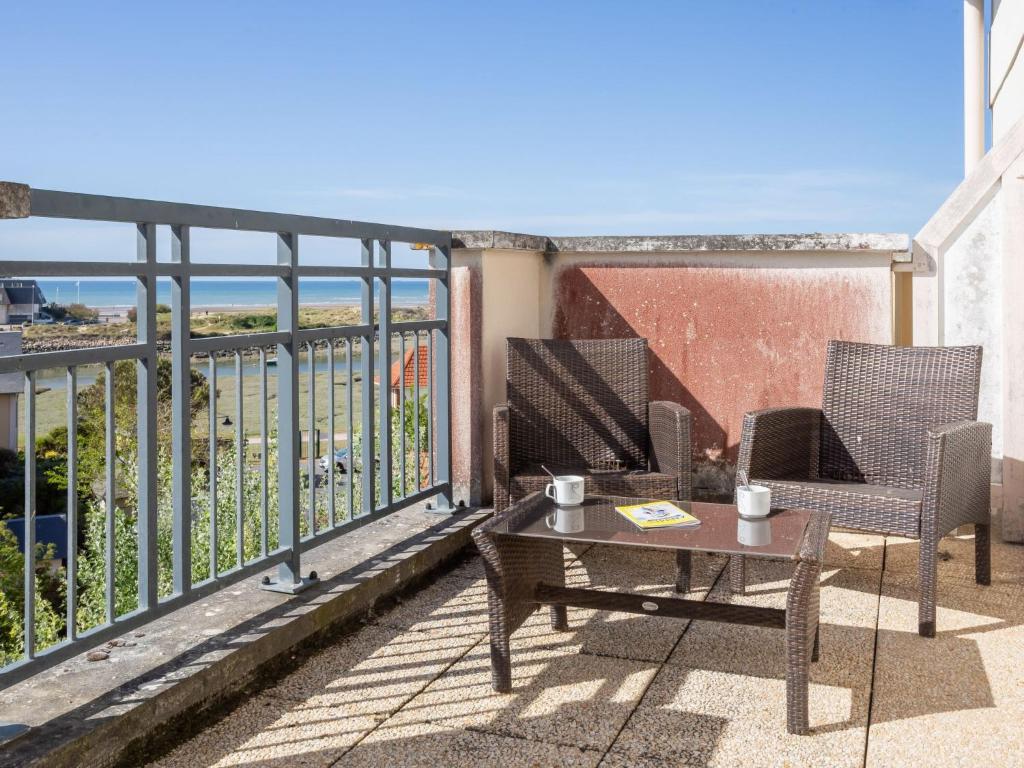 a patio with two chairs and a table on a balcony at Apartment Port Guillaume-6 by Interhome in Cabourg