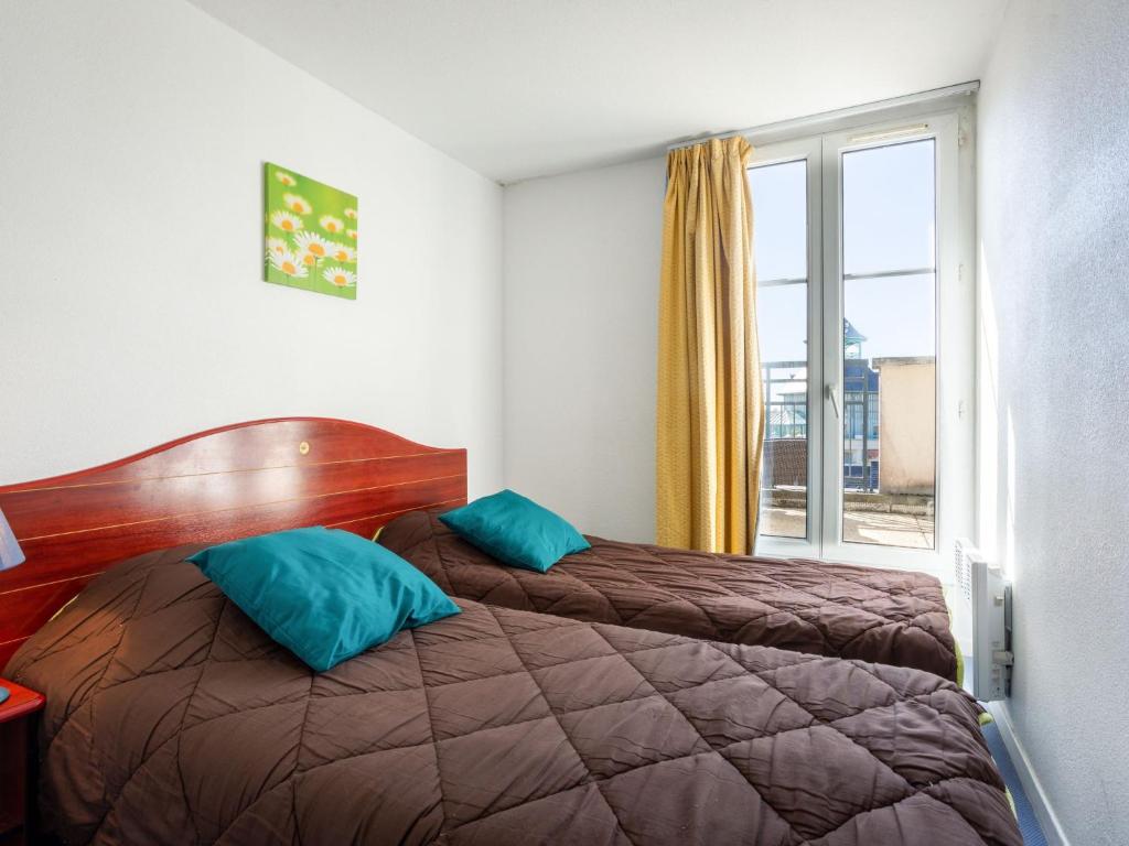 a hotel room with two beds and a window at Apartment Port Guillaume-6 by Interhome in Cabourg