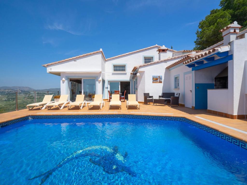 a swimming pool in front of a house at Holiday Home Stuttgart by Interhome in Cumbre del Sol