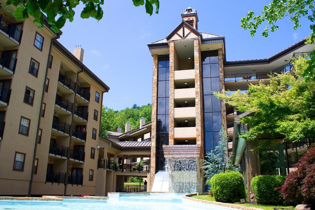 an apartment building with a fountain in front of it at Gatlinburg Town Square by Exploria Resorts in Gatlinburg