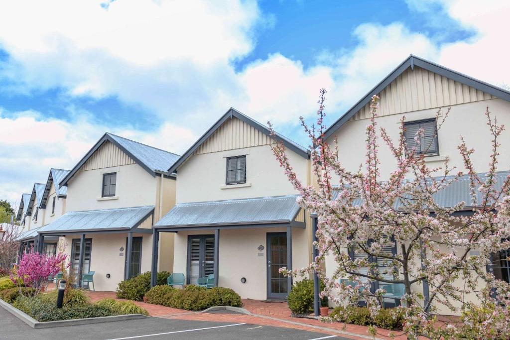 a large white building with black roof at The Studios By Manna, Ascend Hotel Collection in Hahndorf