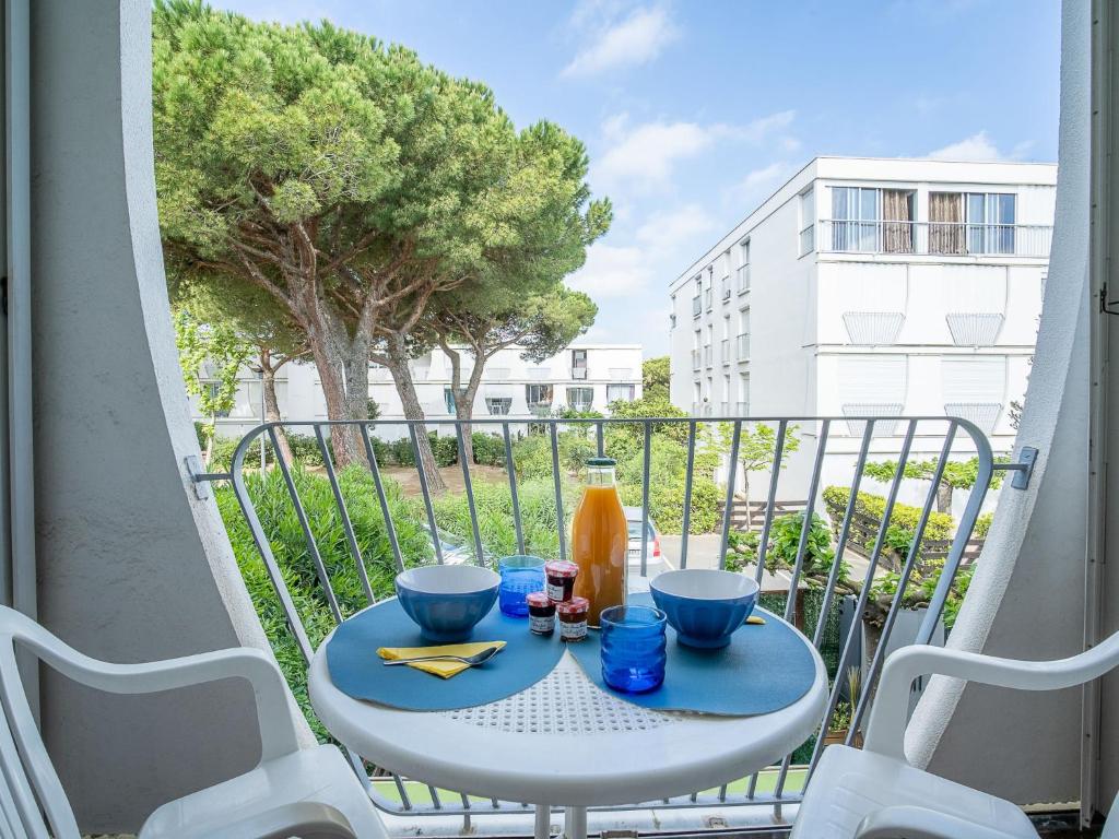 a table on a balcony with a view of a building at Apartment Marin&#39;Land by Interhome in La Grande Motte