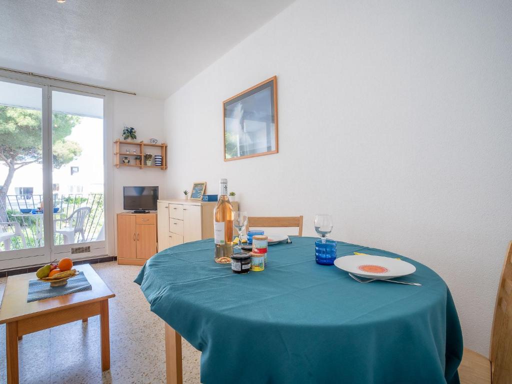 a dining room table with a blue table cloth on it at Apartment Marin&#39;Land by Interhome in La Grande Motte