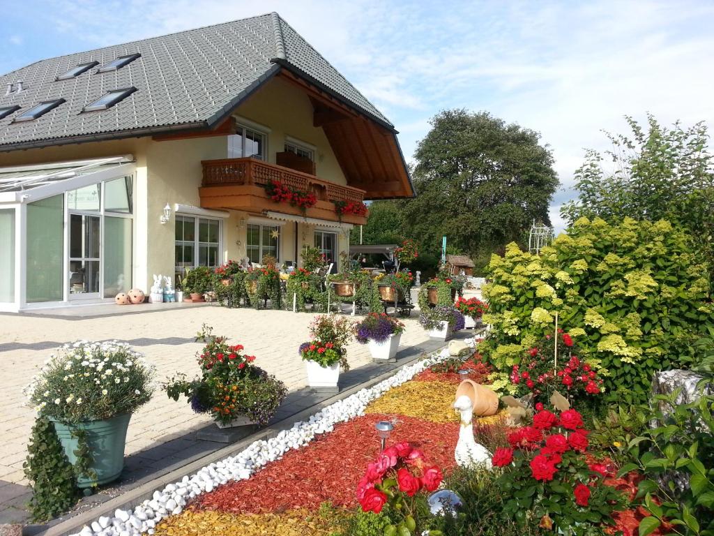 a flower garden in front of a house at Appartement Rehblick in Eisenbach