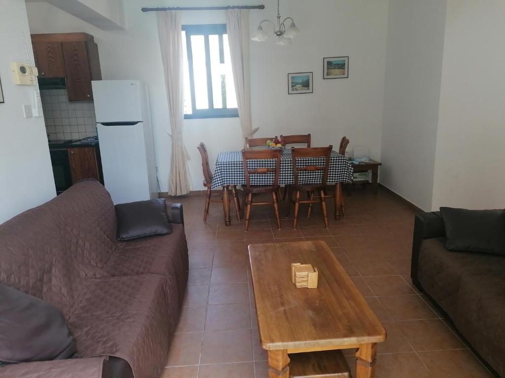 a living room with a couch and a table at Spacious 3 bedroom villa private pool in Paphos City