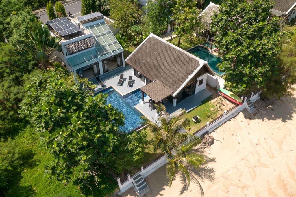 an overhead view of a house with a swimming pool at Beach Front Villa in Ban Bang Po