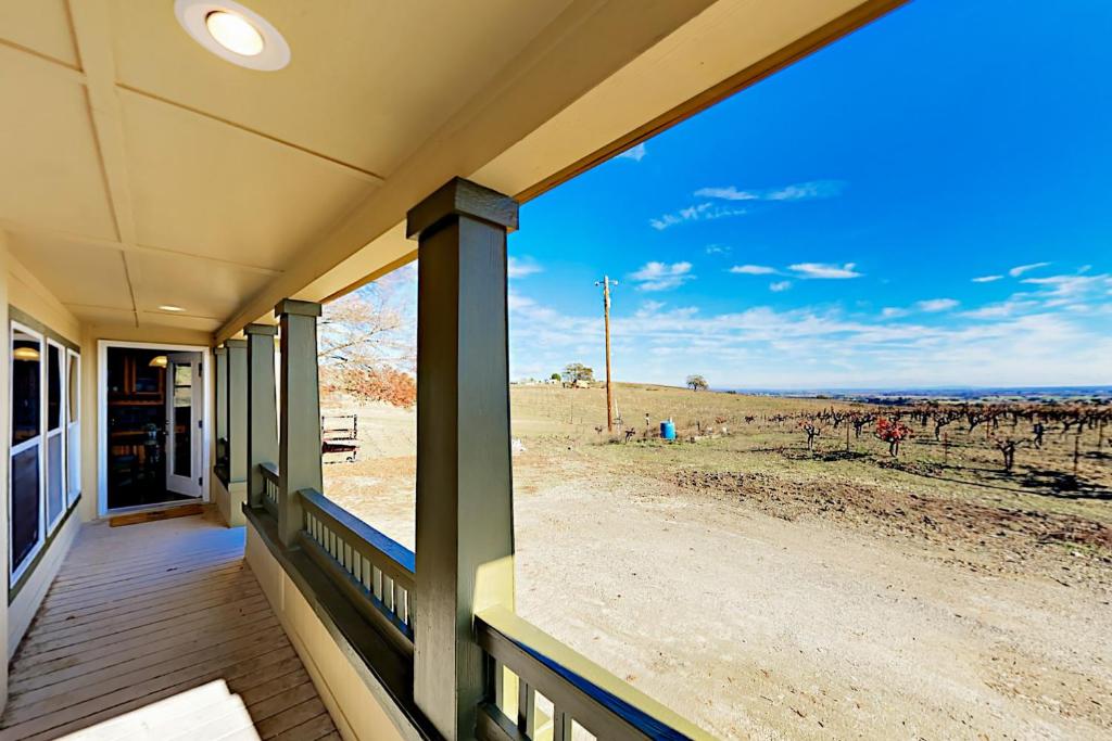 a house with a porch with a view of a field at Nonpariel Escape in Paso Robles