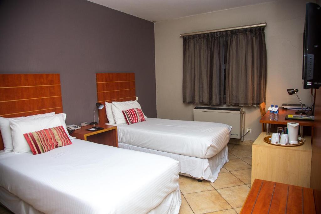 Postel nebo postele na pokoji v ubytování Hotel 2001