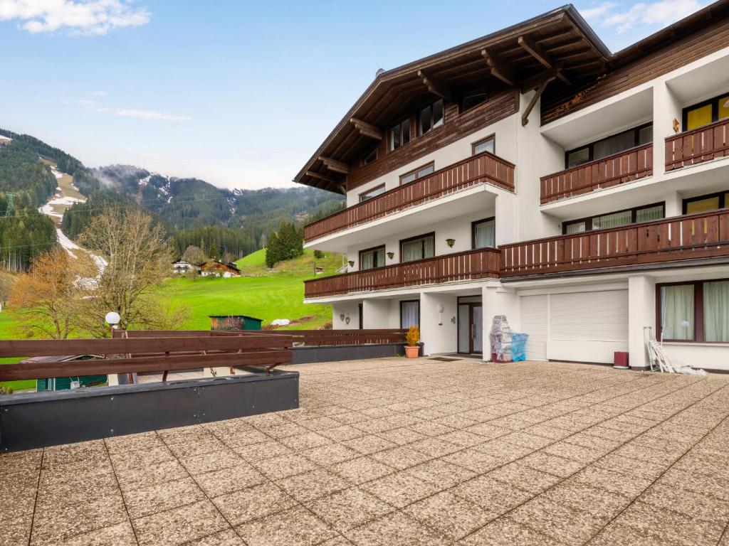 a view of a building with a bench in front at Apartment Holiday-6 by Interhome in Zell am See