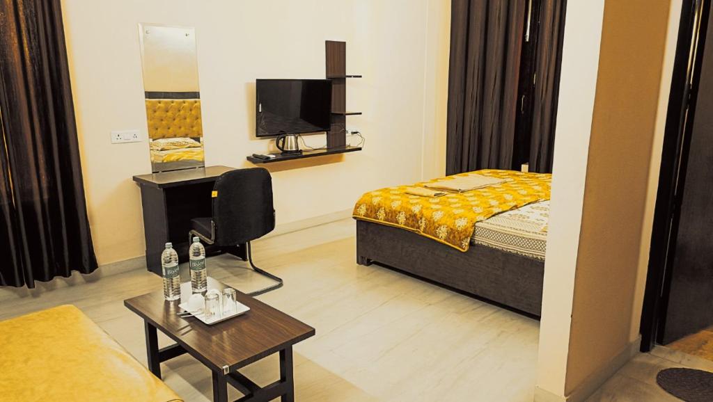 a hotel room with a bed and a tv at Mi Casa Sector 47 in Gurgaon