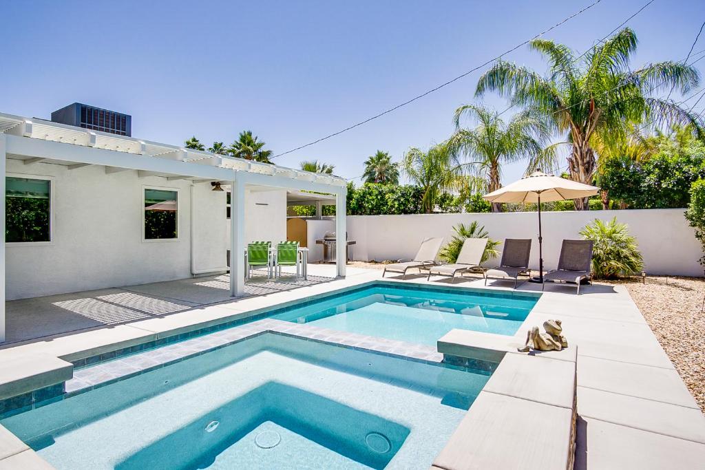 a swimming pool in the backyard of a house at Movie Colony Bungalow Permit# 3364 in Palm Springs
