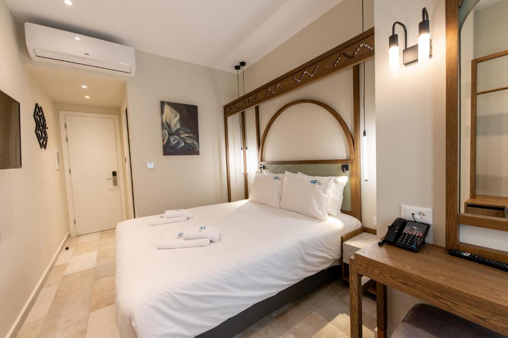 Postel nebo postele na pokoji v ubytování El Greco Hotel