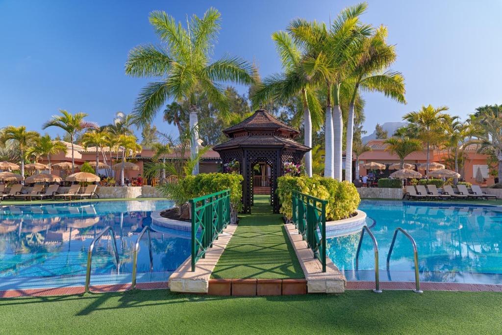 a gazebo in front of a pool at a resort at Green Garden Eco Resort & Villas in Playa de las Americas