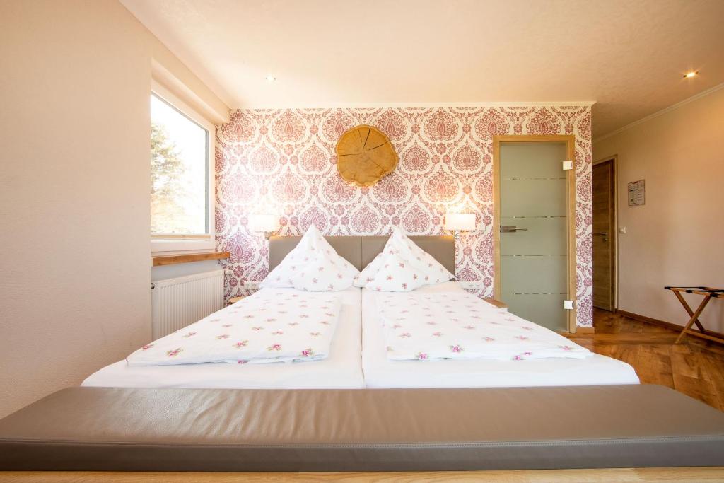 duże białe łóżko w pokoju z oknem w obiekcie Wagners Landhaus w mieście Mehren