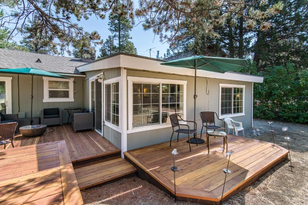 a tiny house with a deck with a table and chairs at Apache Adventures in South Lake Tahoe