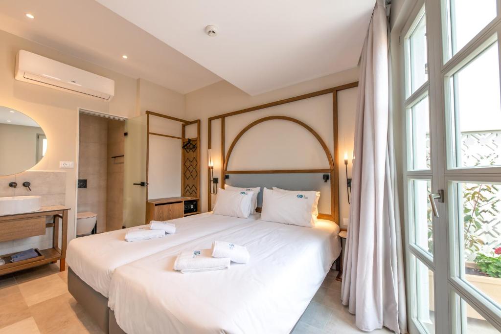 Postel nebo postele na pokoji v ubytování El Greco Hotel