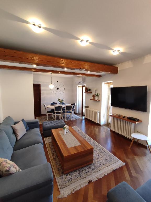 a living room with a couch and a table at Deluxe Apartment Lejla - Free garage parking in Sarajevo