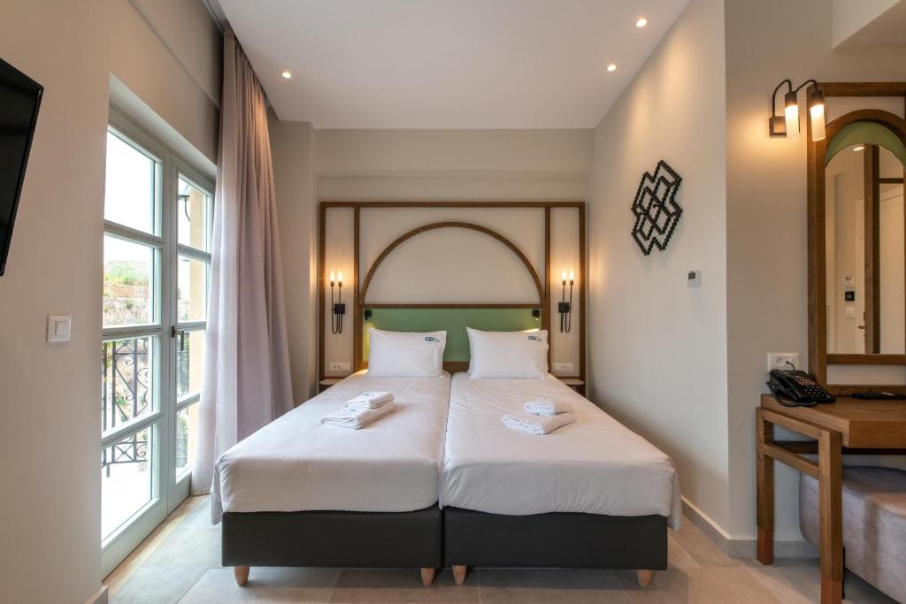 Postel nebo postele na pokoji v ubytování El Greco Hotel