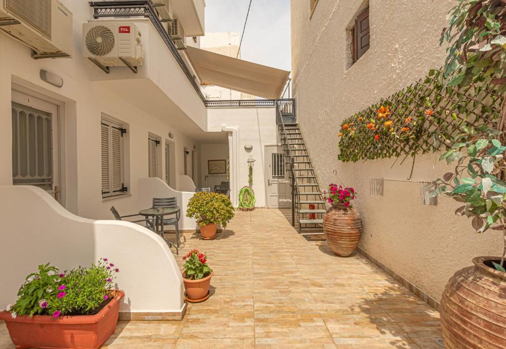 a courtyard of a house with potted plants at Relax Studios in Naxos Chora