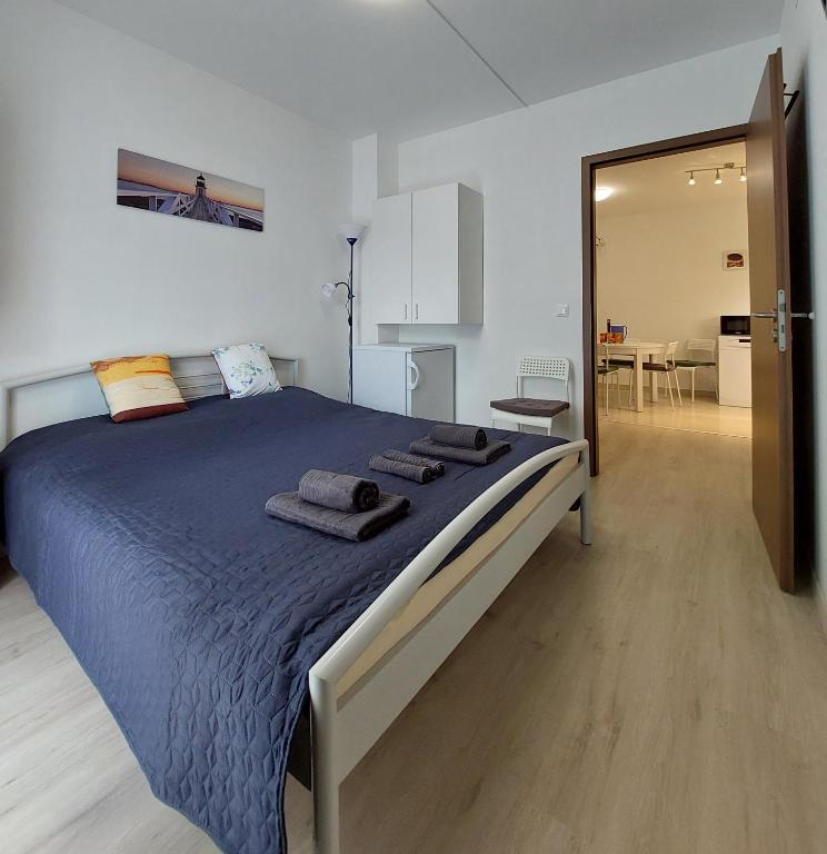 a bedroom with a large bed with towels on it at Arsenal House Budapest in Budapest