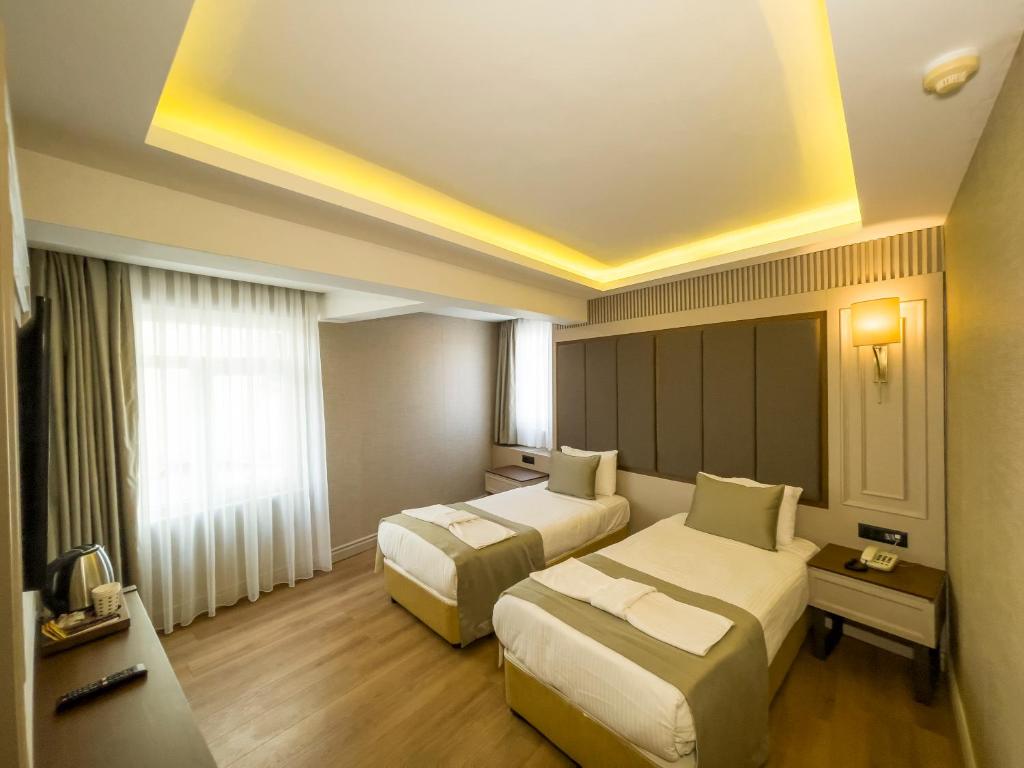 Postel nebo postele na pokoji v ubytování Martinenz Hotel