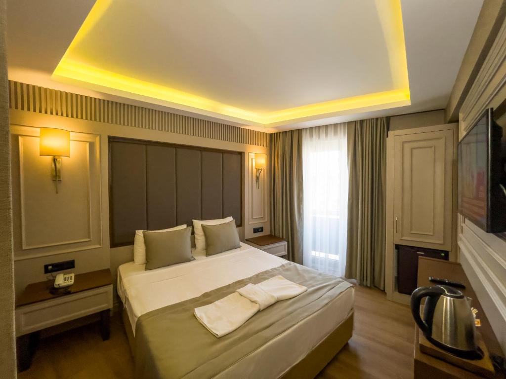 Postel nebo postele na pokoji v ubytování Martinenz Hotel