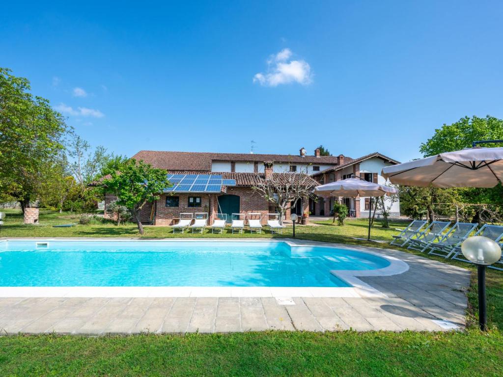 a swimming pool in front of a house at Holiday Home Cascina Anna by Interhome in Basaluzzo