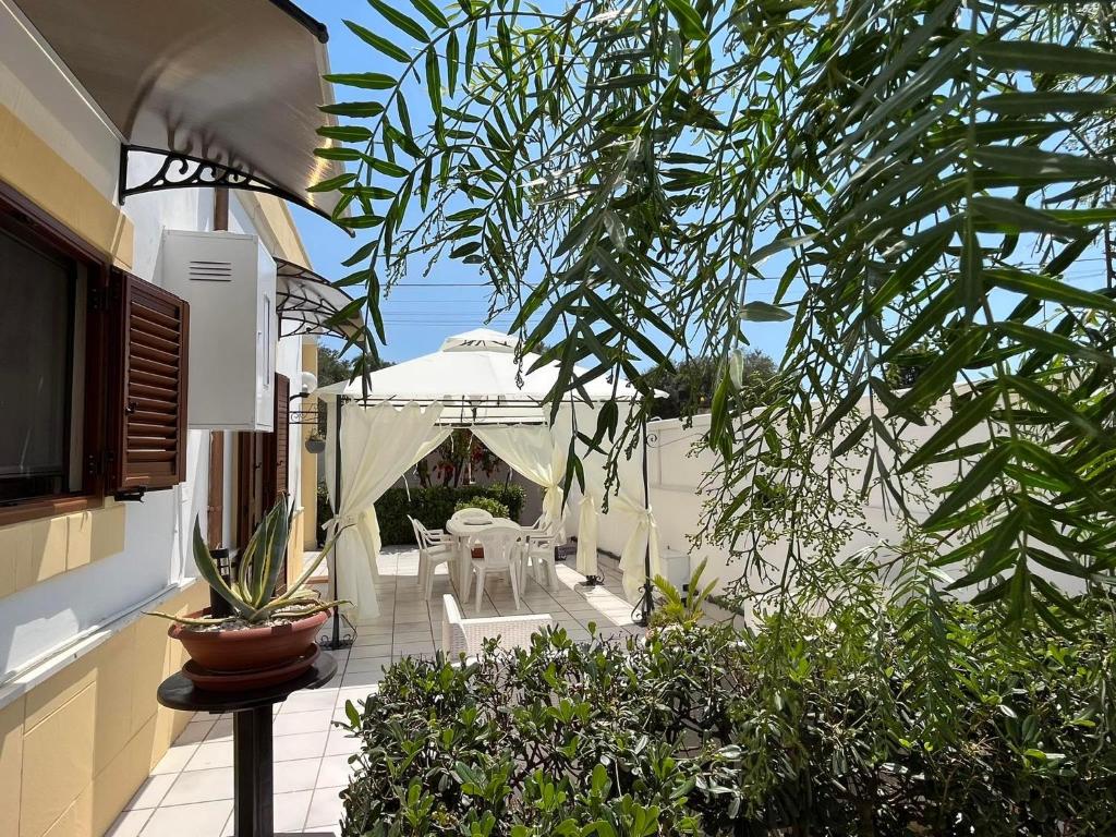 Sava的住宿－Villa Alyson，庭院配有桌椅和植物