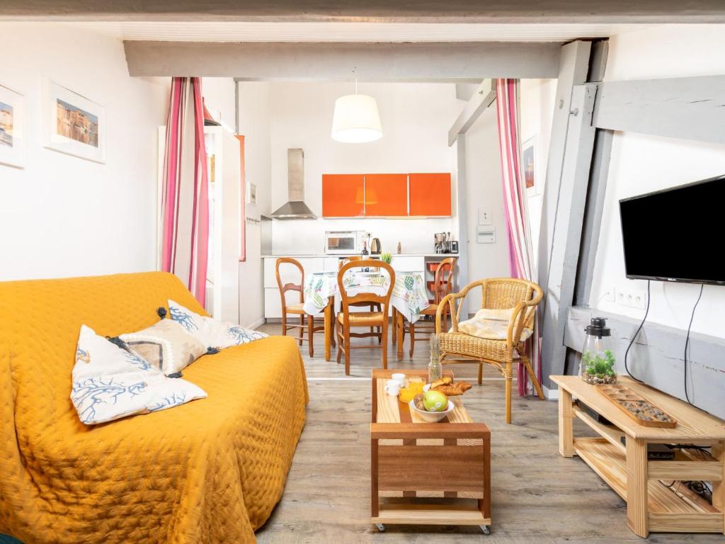 a living room with a yellow couch and a kitchen at Apartment Berasteguia-5 by Interhome in Ciboure