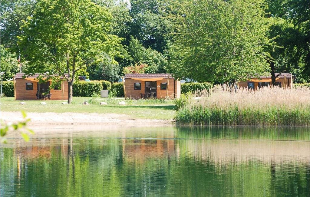 a couple of buildings sitting next to a lake at Amazing Home In Ssel With Wifi in Süsel