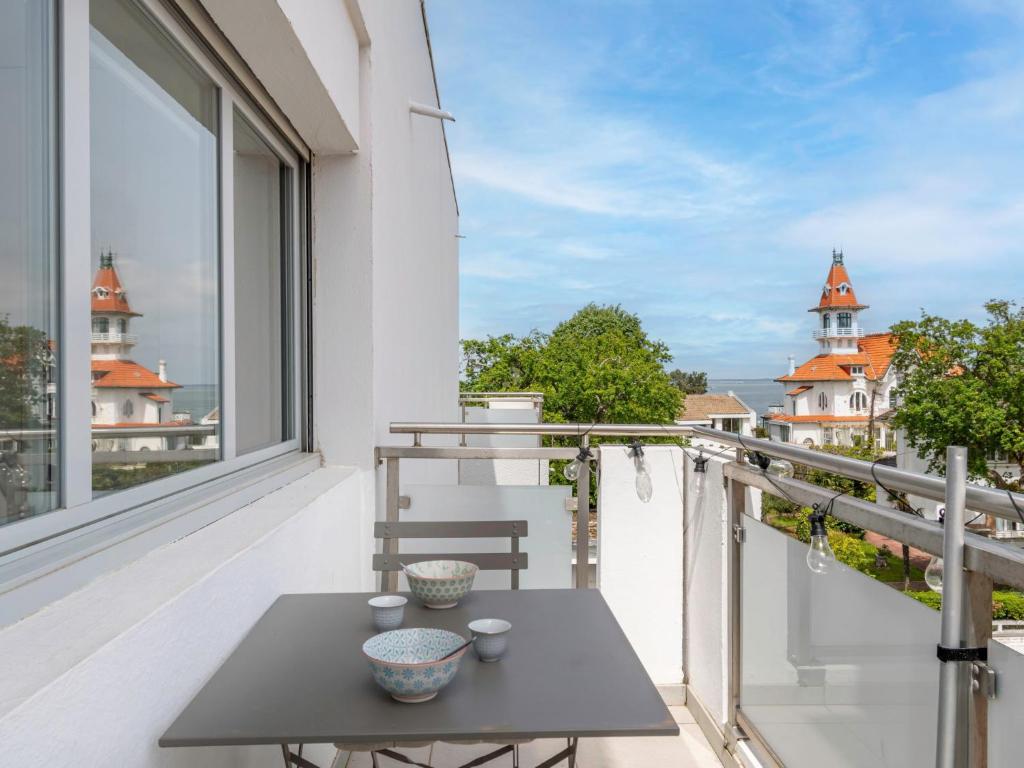 a balcony with a table and a view of the city at Studio Jetée des Marins-5 by Interhome in Arcachon