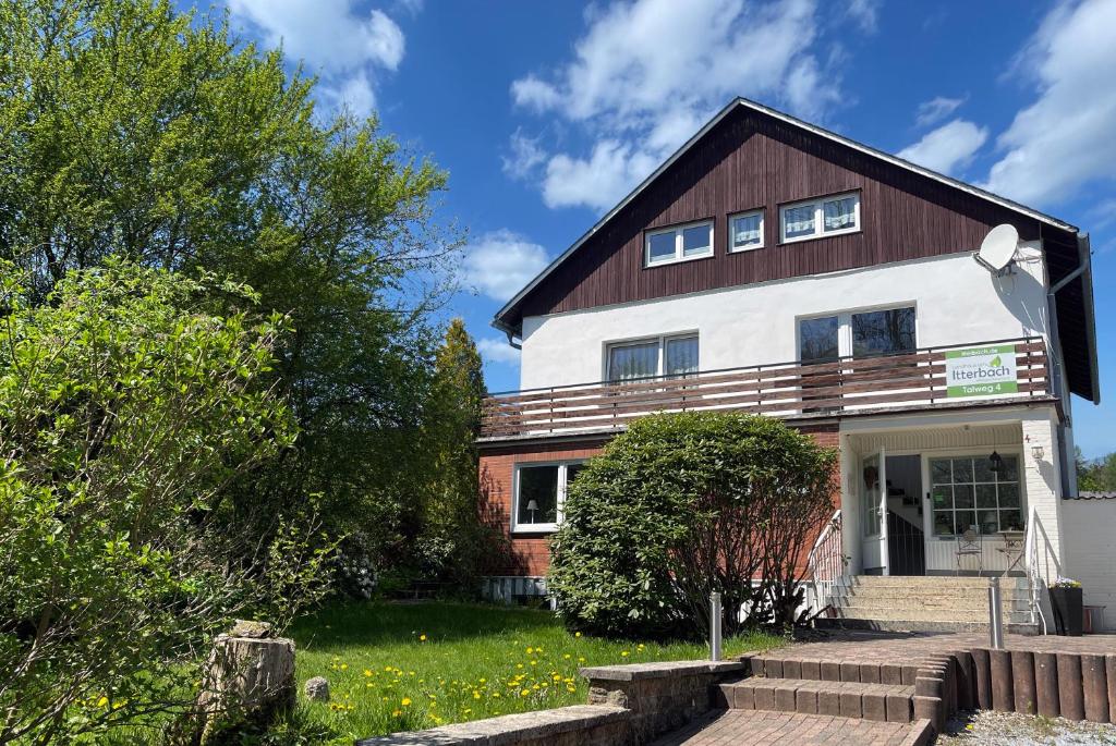 a house with a wooden roof at Landhaus am Itterbach Willingen in Willingen