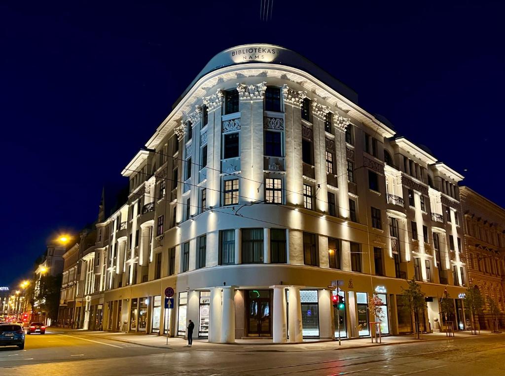 a large building on a city street at night at Library house apartment quiet&compact 2 rooms&beds in Riga