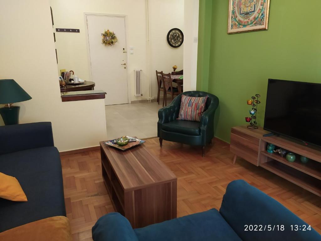 a living room with a couch and a tv at Anna's Flat No2- 2 bedroom apartment in Volos