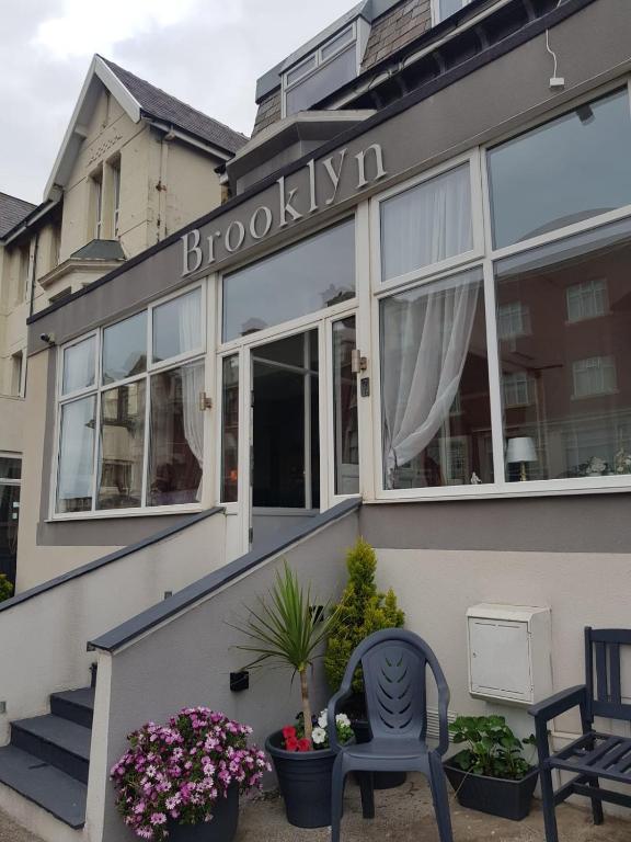 a building with a chair in front of it at Brooklyn Hotel in Blackpool