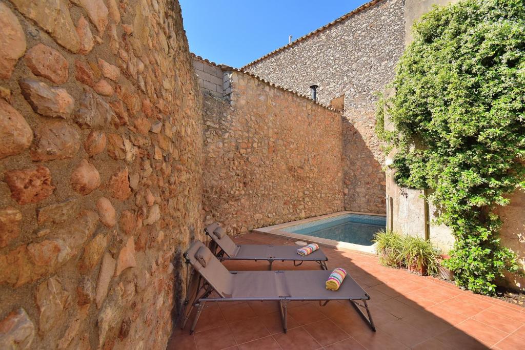 a patio with a table and a swimming pool at Casa Anita 257 by Mallorca Charme in Binissalem