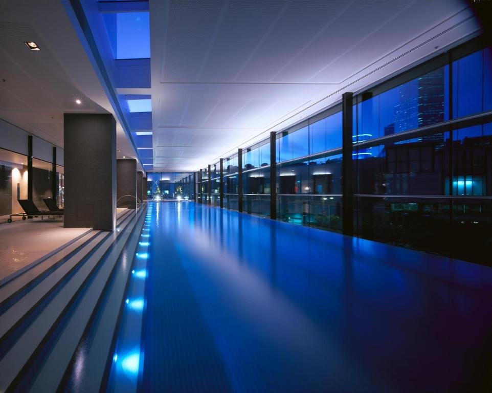 an empty swimming pool in a building at night at Crown Promenade Melbourne in Melbourne