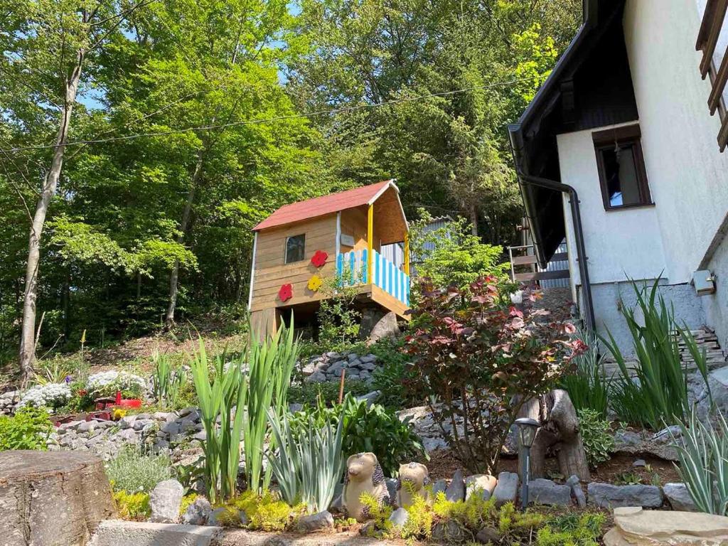 a small house in the middle of a garden at Holiday Home Vanda in Bakar