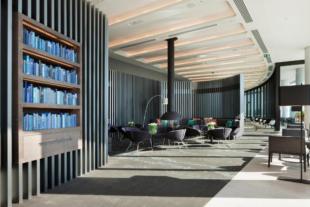 a rendering of a library with chairs and books at Crown Metropol Melbourne in Melbourne