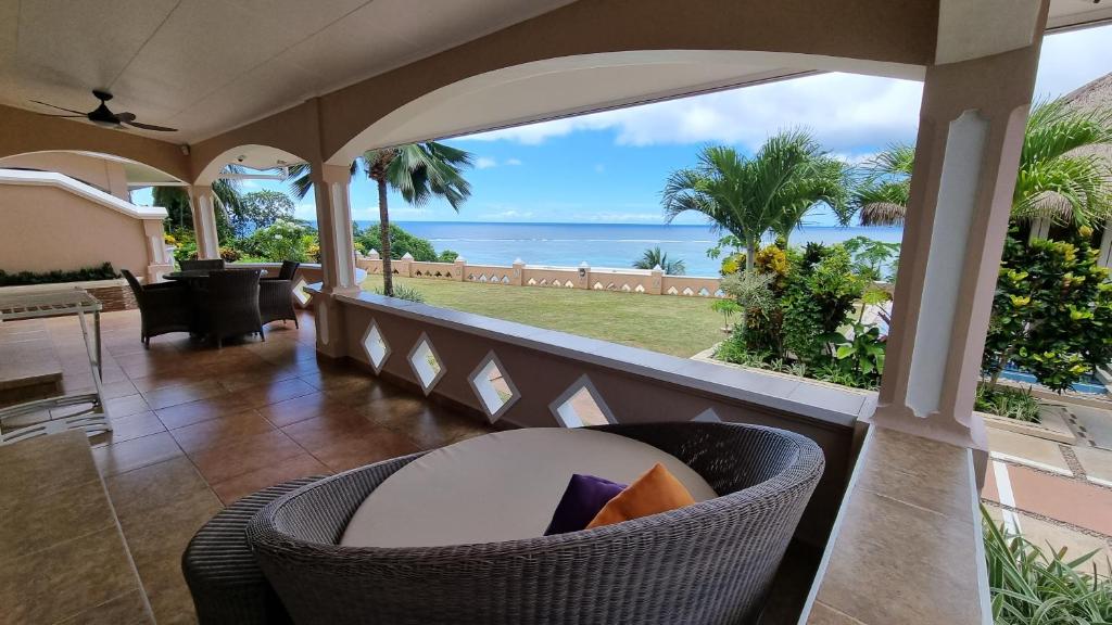 a living room with a view of the ocean at Au Fond De Mer View in Anse Royale