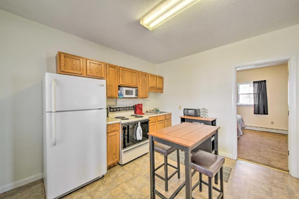 a kitchen with a white refrigerator and a table at Bright Bingham Apt Hunt, ATV and River Raft! in Bingham