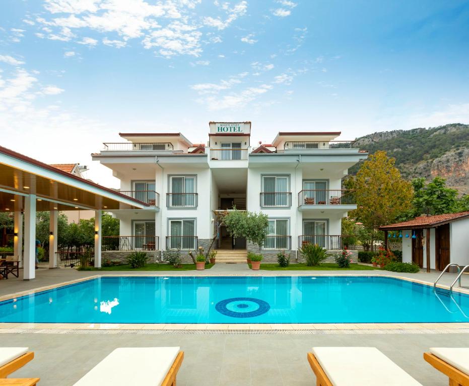 a view of a hotel with a swimming pool at Kerem Apart Hotel in Göcek